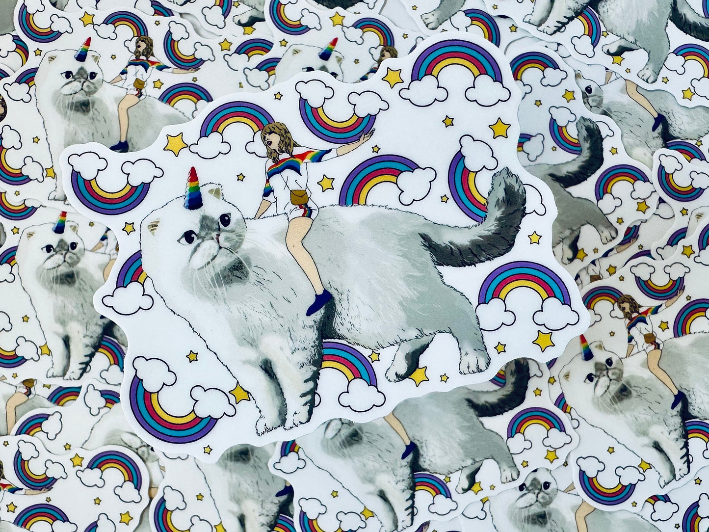 Taylor Riding Cat through Forest, #caticorn commercial, Swift Riding Olivia Benson, Olivia's Rainbow Unicorn Horn, Swiftie Sticker maedaymaedaymaeday