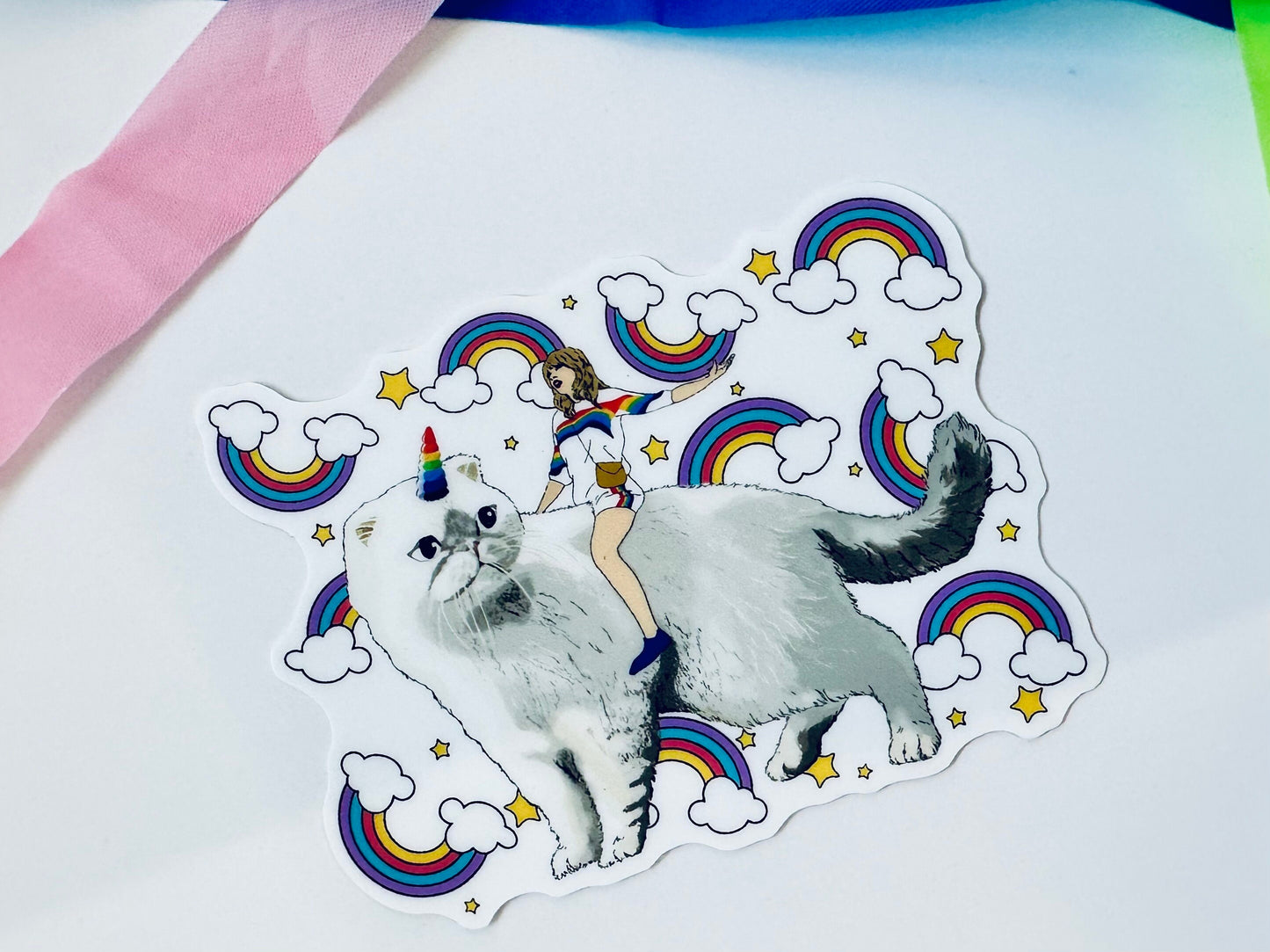 Taylor Riding Cat through Forest, #caticorn commercial, Swift Riding Olivia Benson, Olivia's Rainbow Unicorn Horn, Swiftie Sticker maedaymaedaymaeday