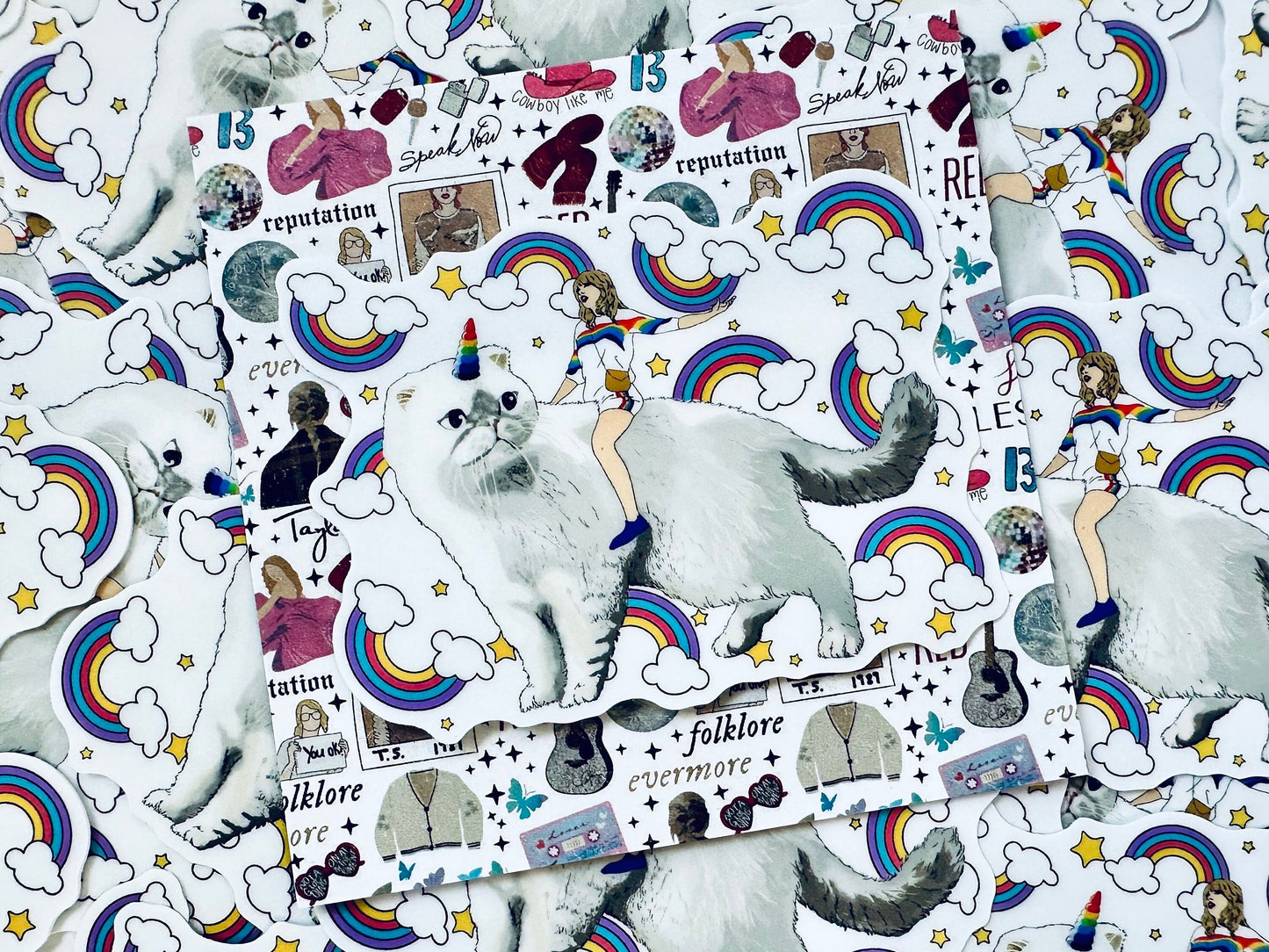 Taylor Riding Cat through Forest, #caticorn commercial, Swift Riding Olivia Benson, Olivia's Rainbow Unicorn Horn, Swiftie Sticker maedaymaedaymaeday