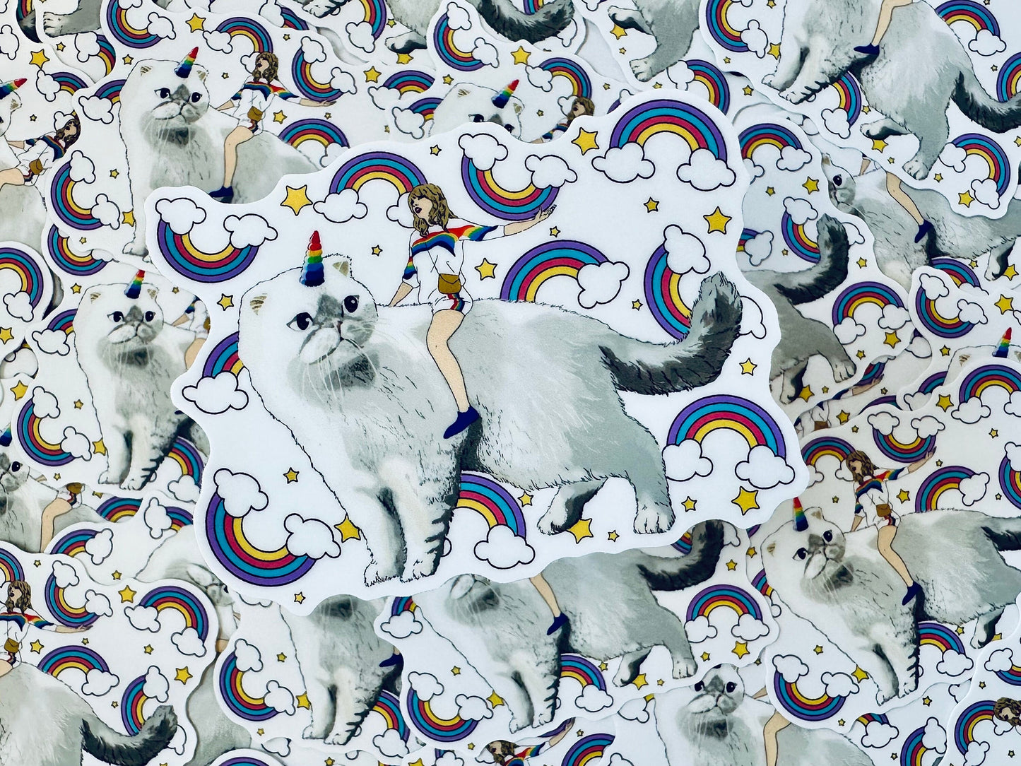 Taylor Riding Cat through Forest, #caticorn commercial, Swift Riding Olivia Benson, Olivia's Rainbow Unicorn Horn, Swiftie Sticker maedaymaedaymaeday